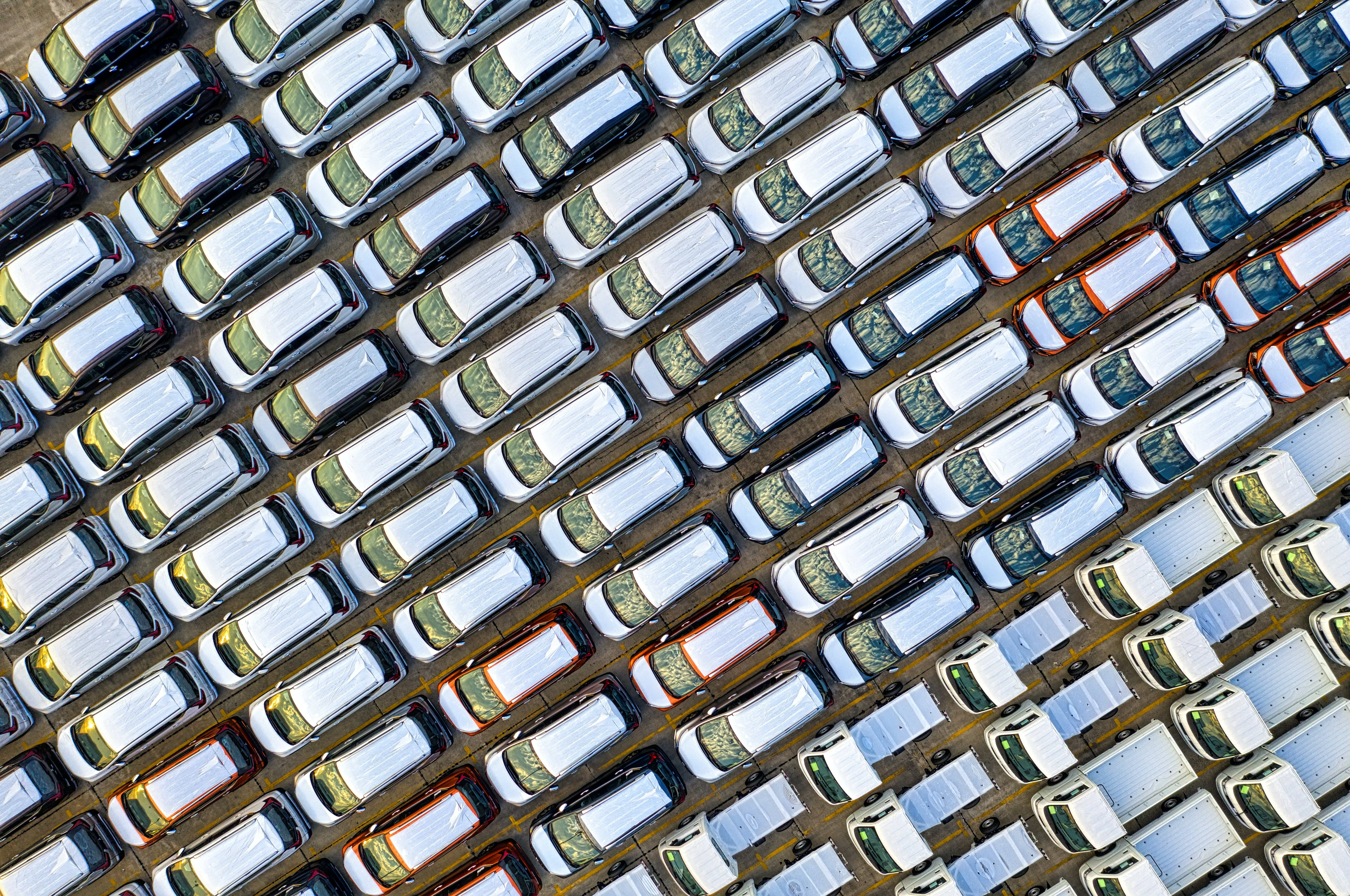Aerial view of rows of new vehicles awaiting distribution